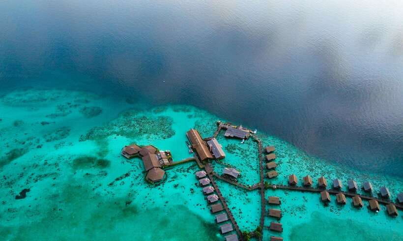 Semporna: Mabul and Kapalai Trip in Snorkel or Dive & Lunch - Mabul’s bungalows, water village, and resort stop